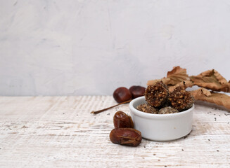 Dry fruit balls. Homemade candy with date and peanut, and banana. White background. Copy spase