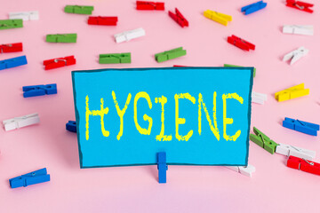 Text sign showing Hygiene. Business photo showcasing study of science of the establishment and maintenance of health Colored clothespin papers empty reminder pink floor background office pin