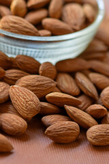 Almonds in bowl, Group of almond nuts isolated on white background. Depth of field