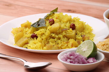Aloo/Kanda Poha or Pohe with onion. Served in ceramic plate.