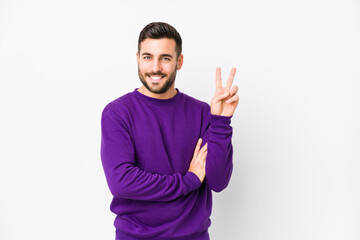 Fototapeta premium Young caucasian man against a white background isolated showing number two with fingers.