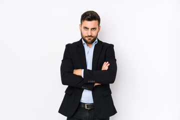 Young caucasian business man against a white background isolated frowning face in displeasure,...