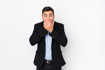 Young caucasian business man against a white background isolated shocked covering mouth with hands.
