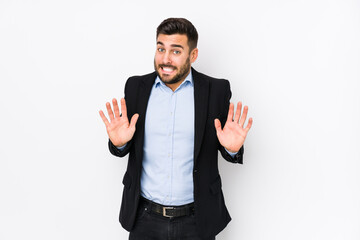 Young caucasian business man against a white background isolated rejecting someone showing a...