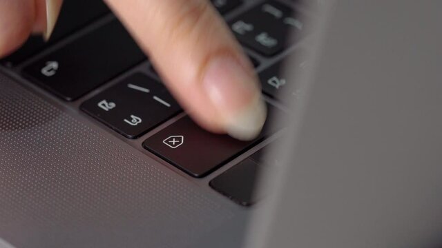 close-up female hand pressing a Backspace key for delete on a laptop keyboard