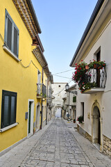 A narrow street among the old houses of San Marco dei Cavoti, a small town in the province of Benevento, Italy.