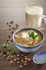 Tofu pudding dessert of soybean pudding in ginger and palm sugar syrup. Malaysian Food