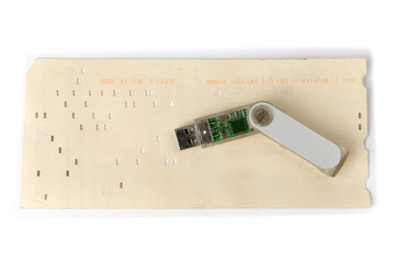 the history of computer data storage, vintage 80 column computer punch card and a modern USB memory key