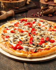 Closeup on pizza with mushrooms and tomatoes