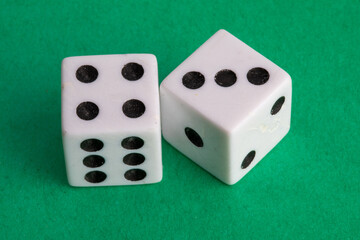 lucky seven - a pair of dice on a green background showing four and three