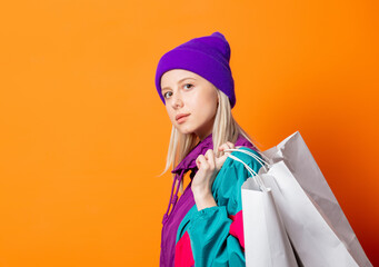 Style woman in 90s tracksuit with shopping bags