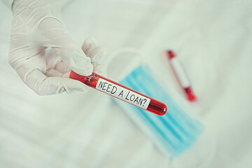 Naklejka premium Text sign showing Need A Loanquestion. Business photo showcasing offering a money for an individualal or business finances Extracted blood sample vial ready for medical diagnostic examination