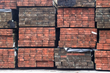end grain of stacks of heavy industrial pressure treated wood planks
