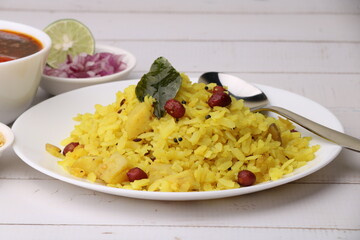 Aloo/Kanda Poha or Pohe with onion. Served in ceramic plate.
