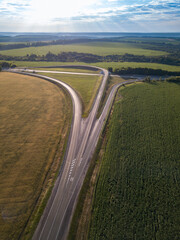 Aerial Top View of highway intersection junction summer morning with car