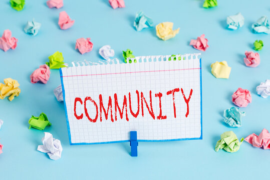 Handwriting text Community. Conceptual photo group of showing with a common characteristics living together Colored crumpled papers empty reminder blue floor background clothespin