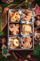 Sweet gingerbread cookies for Christmas decorated with spruce and nuts