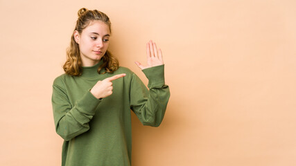 Young caucasian woman isolated on beige background smiling cheerful showing number five with fingers.