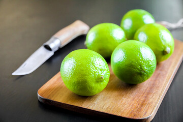 Lime and old traditional pocket knife on a cutting board