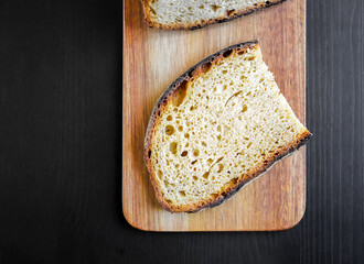 Traditional French country bread slices on a cutting board