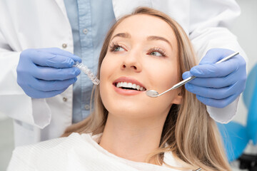 Woman having teeth examined at dentists