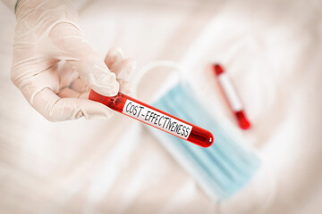 Naklejka premium Text sign showing Cost Effectiveness. Business photo showcasing degree to which something is effective in relation to its cost. Extracted blood sample vial ready for medical diagnostic examination