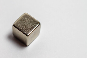 Steel magnetic cube on a white background.