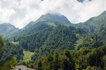 Naklejka premium Misty mountain landscape with fir forest. Beautiful landscape with mountain view, cable car. Postcard view. Travel concept