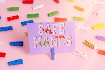 Handwriting text writing Safe Hands. Conceptual photo Ensuring the sterility and cleanliness of the hands for decontamination Colored clothespin papers empty reminder pink floor background office pin