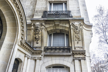 Old French house with traditional balconies and windows. Paris, France.