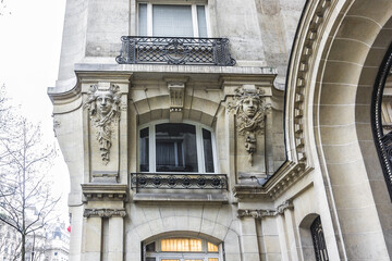 Old French house with traditional balconies and windows. Paris, France.