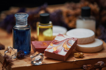 Shampoo and soap products on wooden board