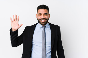 Young latin business woman against a white background isolated smiling cheerful showing number five with fingers.