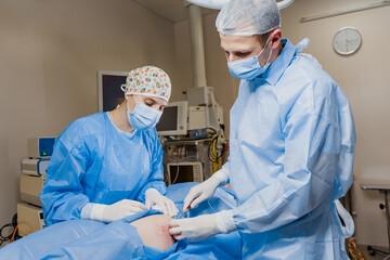 Liposuction for lipofilling surgery operation. 2 surgeon do plastic surgery named blepharoplasty in medical clinic.