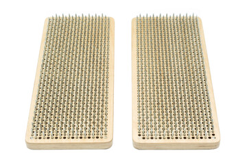 The bed of nails for meditation isolated on white background. Sadhu Board for the practice of standing on nails.