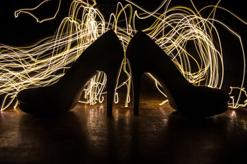 Silhouette of a high heel women shoes at dark. Women power or women domination concept.
