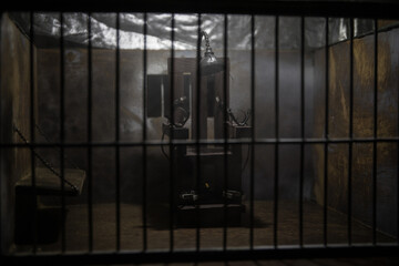 Jail or prison cell. Obsolete gray grunge concrete room. Old prison miniature. Execution concept