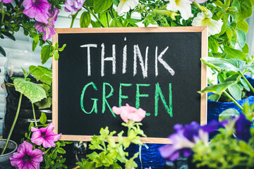 sign with the inscription "Think Green" in the background of nature