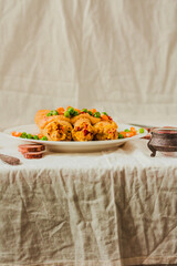 Gluten-free keto Crepes filled with paprika hummus in the oven with curry sauce and sweet corn and green peas on top