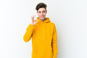 Young caucasian man isolated on white background cheerful and confident showing ok gesture.