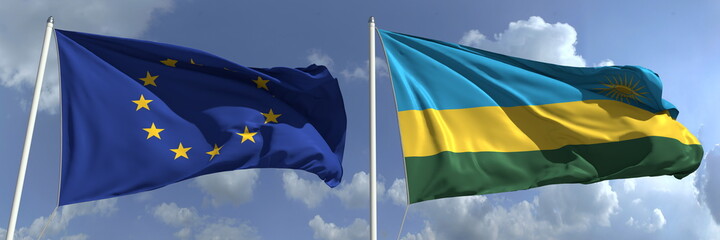 Flags of the European Union and Rwanda on flagpoles. 3d rendering