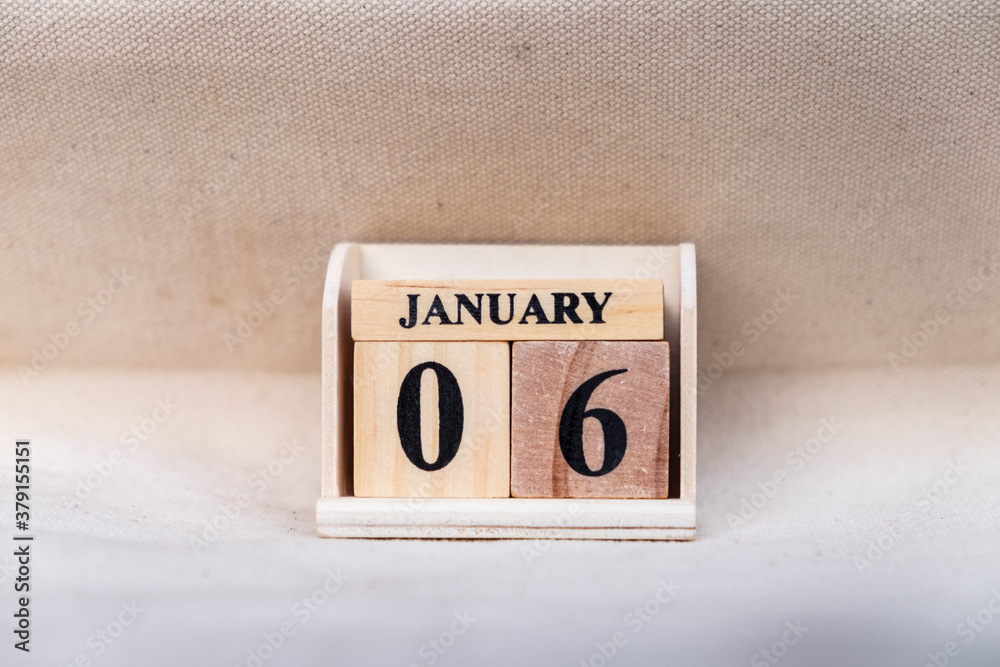 Fototapete january 6th. image of jan 6 wooden color calendar on white canvas background. empty space for text