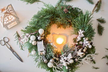 Beautifully decorated advent wreath with white decoration on a table