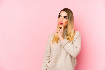 Middle age woman over isolated background looking sideways with doubtful and skeptical expression.