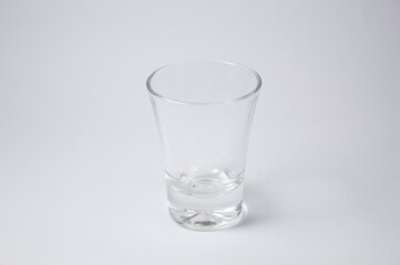 Small glass cup on white background