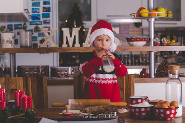 Happy children, boy brothers, baking christmas cookies at home
