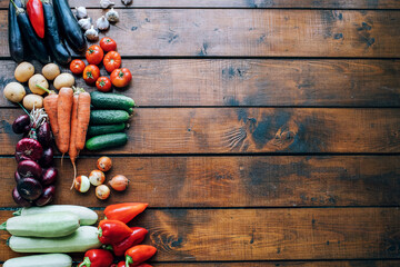 Vegetables of different colors on a dark textured background with an empty place for an inscription top view