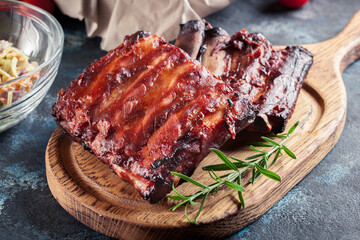 Spicy barbecued pork ribs served with BBQ sauce