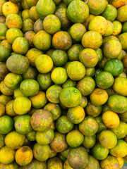 Heaps of oranges that are commercially available as fruit or to make high-vitamin juices organized into groups, use them as background images.