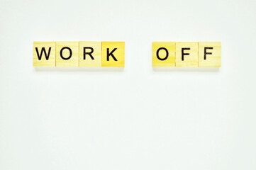 Word work off. Wooden blocks with lettering on top of white background. Top view of wooden blocks with letters on white surface